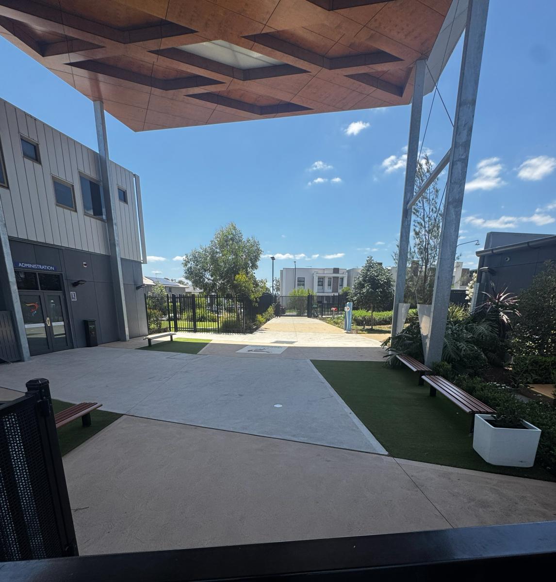 Modern commercial building exterior with clean concrete forecourt and professional landscaping