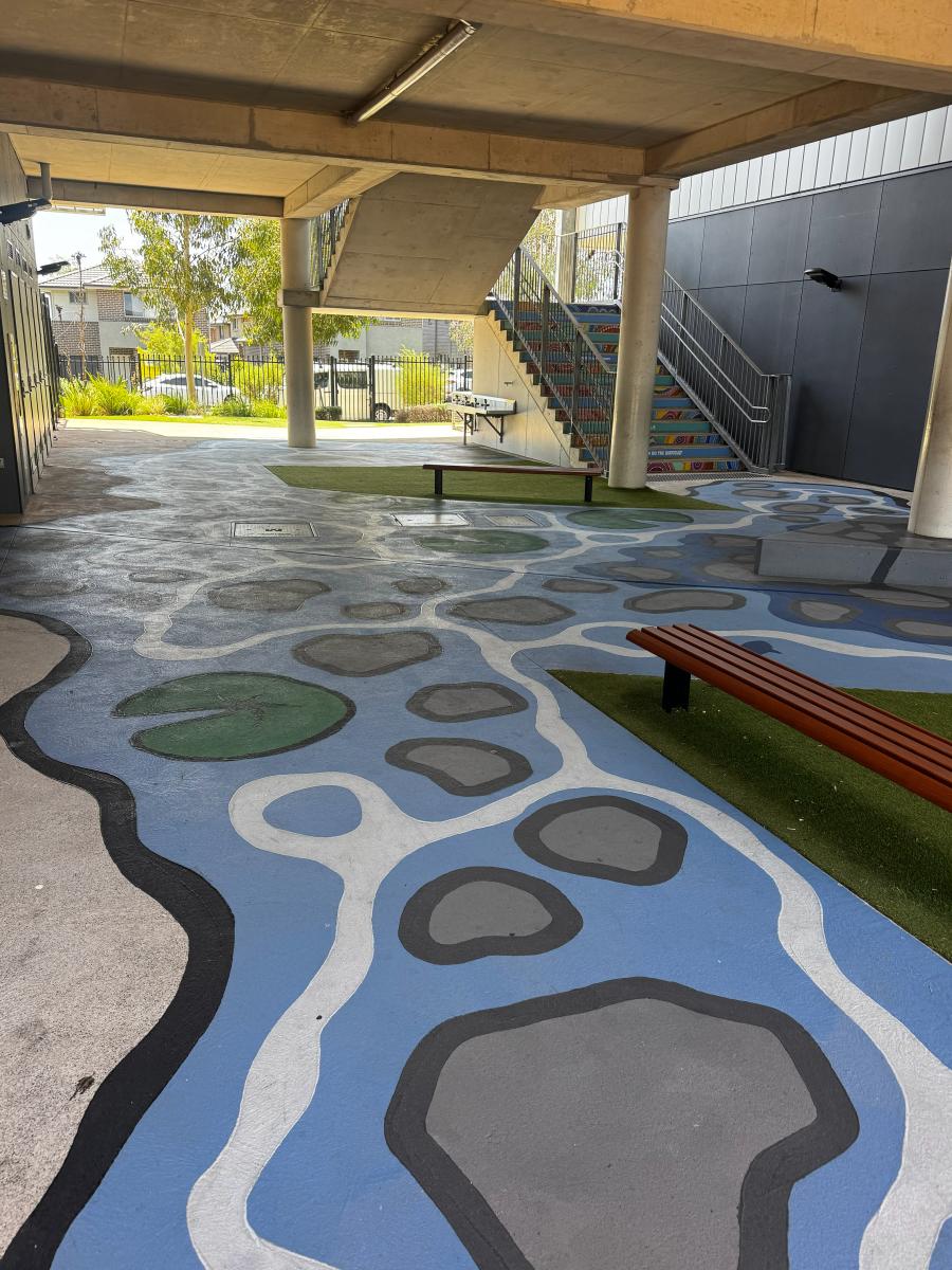 Modern blue and grey polished concrete floor with abstract pattern in covered outdoor carpark